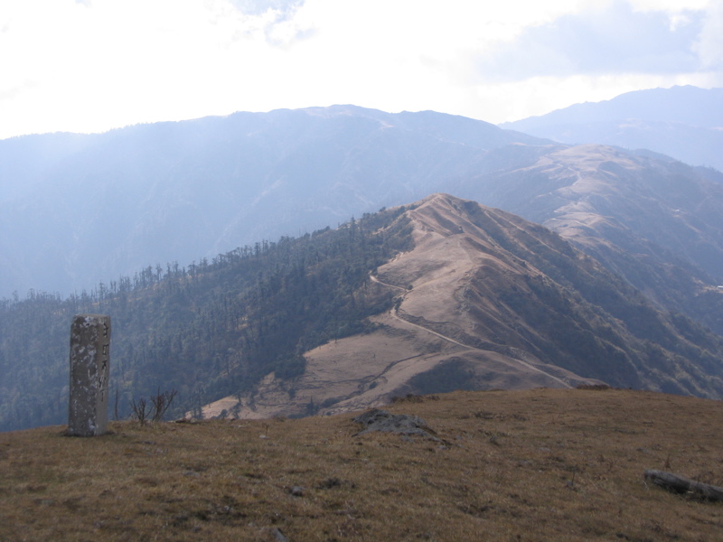 The ridge from where we had come and a border stone on Phalut; India is on the left, Nepal is on the right